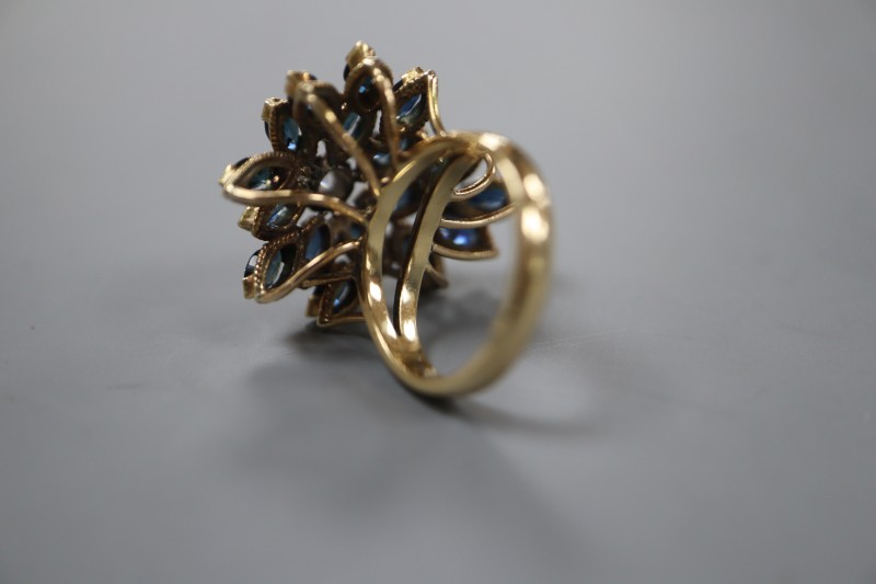 A 14k yellow metal, sapphire and diamond set raised cluster dress ring, of flowerhead design, size M, gross weight 9.2 grams.